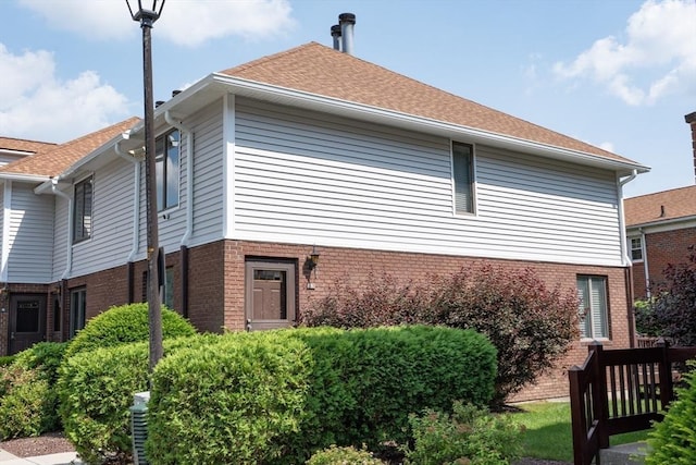 1051 Elm St Unit 8, West Springfield, MA 01089 - view of side of property with brick siding and roof with shingles