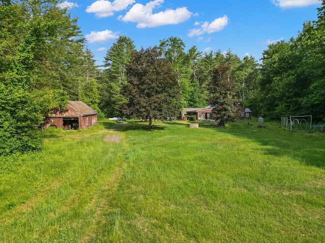 2 Tenney Ct, Georgetown, MA 01833 - view of green lawn featuring a wooded view and an outdoor structure