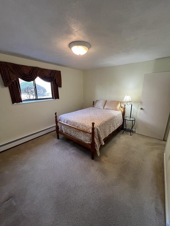 20 Colonial Dr Unit 3, Andover, MA 01810 - bedroom featuring carpet flooring, baseboard heating, and a textured ceiling