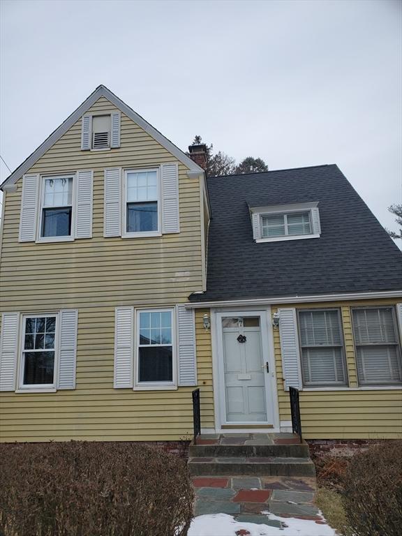 view of front of house featuring entry steps and a chimney