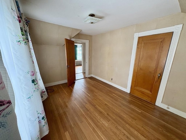 empty room with baseboards and wood finished floors