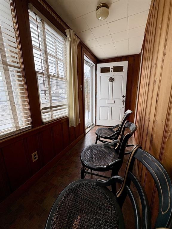 sitting room featuring wood walls and wood finished floors