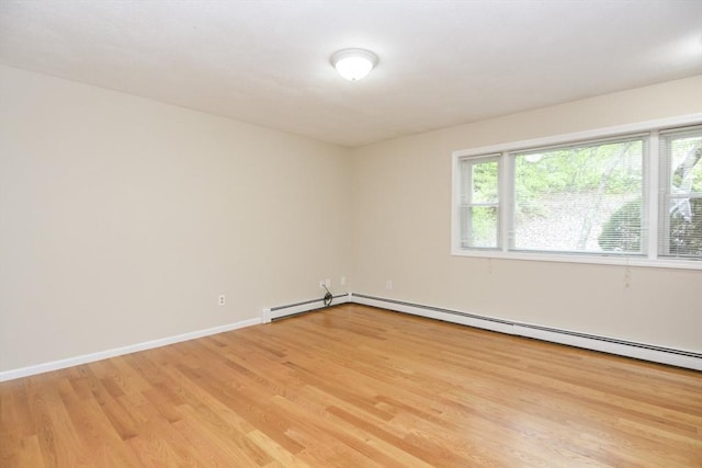 154 E Bacon St Unit B6, Plainville, MA 02762 - unfurnished room featuring light wood-style floors, baseboards, and a baseboard heating unit
