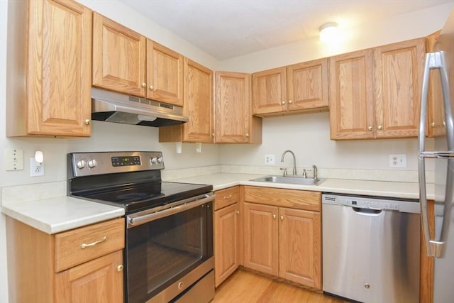 154 E Bacon St Unit B6, Plainville, MA 02762 - kitchen featuring appliances with stainless steel finishes, under cabinet range hood, a sink, and light countertops