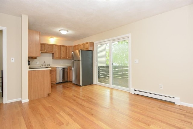 154 E Bacon St Unit B6, Plainville, MA 02762 - kitchen featuring appliances with stainless steel finishes, baseboard heating, light wood-style floors, light countertops, and baseboards