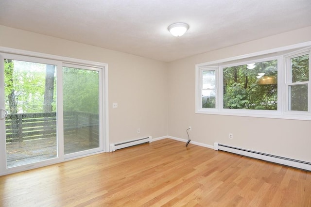 154 E Bacon St Unit B6, Plainville, MA 02762 - spare room with a baseboard heating unit, light wood finished floors, and baseboards