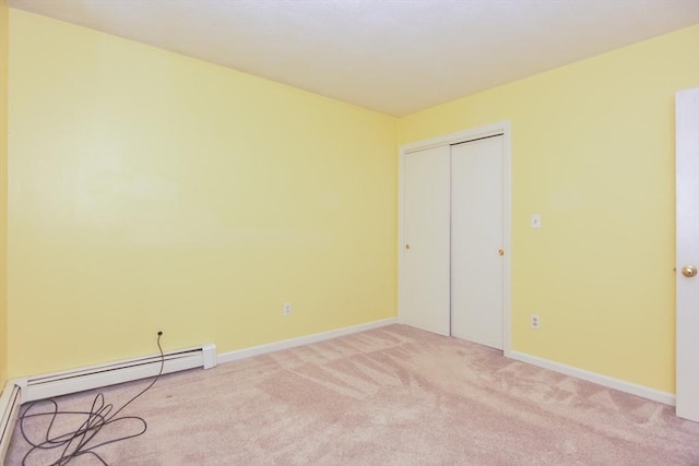154 E Bacon St Unit B6, Plainville, MA 02762 - unfurnished bedroom with light colored carpet, baseboards, a closet, and a baseboard heating unit