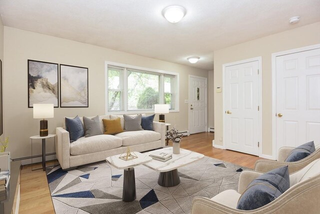 154 E Bacon St Unit B6, Plainville, MA 02762 - living room featuring light wood-style floors, baseboard heating, and a baseboard radiator