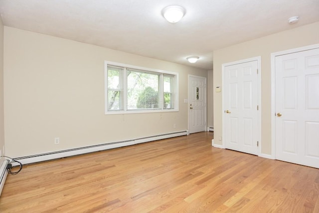 154 E Bacon St Unit B6, Plainville, MA 02762 - unfurnished bedroom with a baseboard heating unit and light wood-style flooring