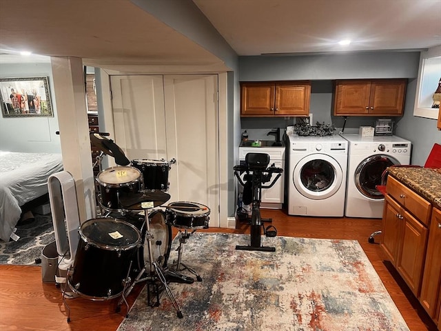 clothes washing area featuring separate washer and dryer and hardwood / wood-style floors