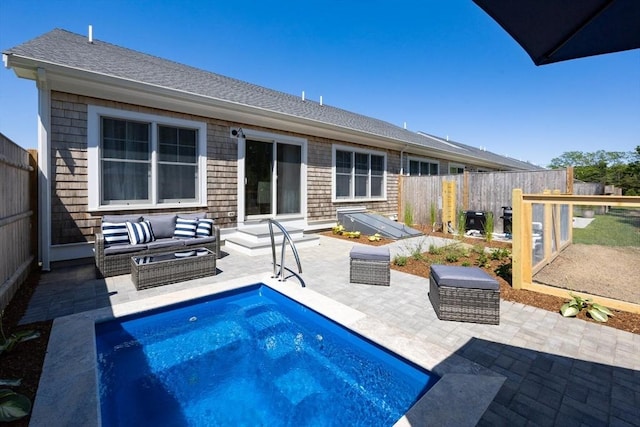 rear view of property featuring an outdoor hangout area, a patio area, and a fenced in pool