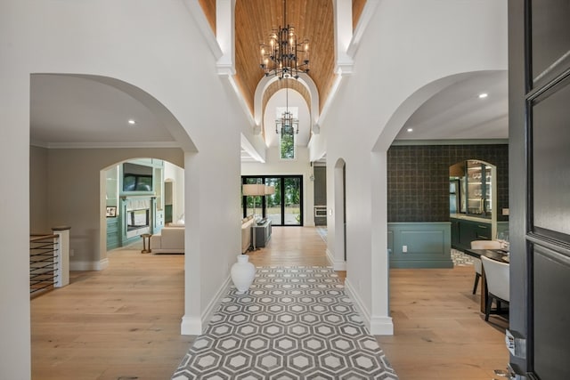 entryway with a high ceiling, an inviting chandelier, and light hardwood / wood-style floors