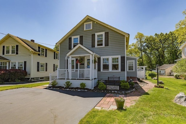 21 Alfred St, Woburn, MA 01801 - traditional-style house featuring covered porch and a front lawn