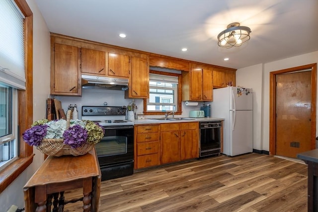 21 Alfred St, Woburn, MA 01801 - kitchen featuring range with electric cooktop, under cabinet range hood, black dishwasher, a sink, and freestanding refrigerator