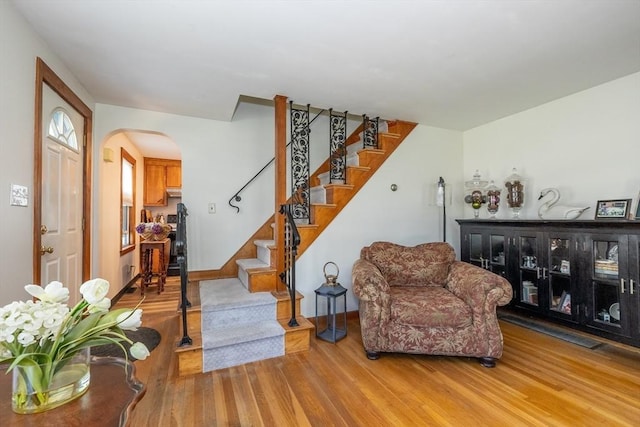 21 Alfred St, Woburn, MA 01801 - living area featuring wood finished floors, arched walkways, stairway, and baseboards