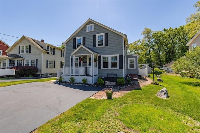 21 Alfred St, Woburn, MA 01801 - view of front facade with a porch and a front lawn