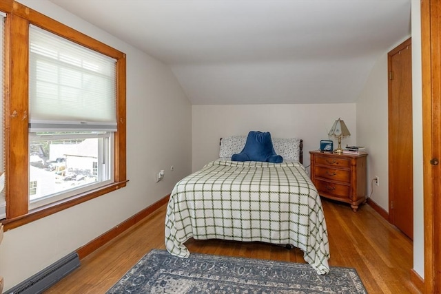 21 Alfred St, Woburn, MA 01801 - bedroom featuring lofted ceiling, baseboard heating, wood finished floors, and baseboards