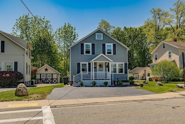 21 Alfred St, Woburn, MA 01801 - view of front of home featuring an outbuilding, a front yard, and covered porch
