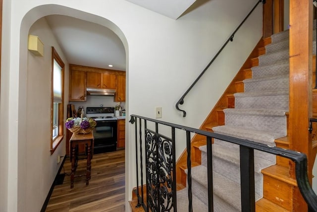 21 Alfred St, Woburn, MA 01801 - stairway featuring arched walkways, wood finished floors, and recessed lighting