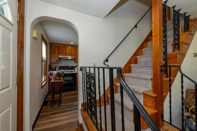 21 Alfred St, Woburn, MA 01801 - stairway featuring wood finished floors, arched walkways, and recessed lighting