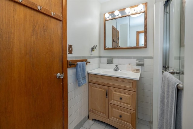 21 Alfred St, Woburn, MA 01801 - bathroom with tile walls, vanity, tile patterned floors, and a wainscoted wall