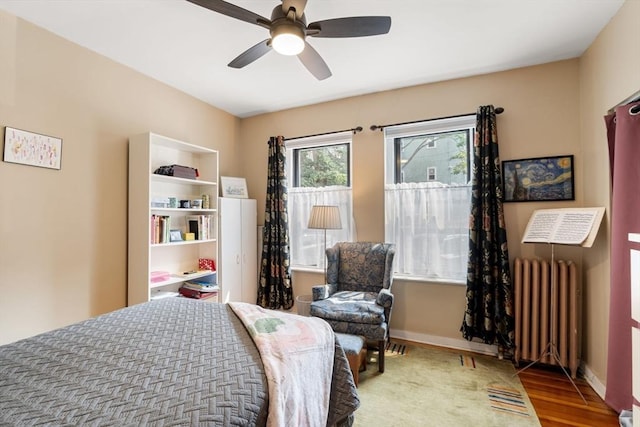 1404 Commonwealth Ave Unit 4-8, Boston, MA 02135 - bedroom featuring radiator heating unit, wood finished floors, and a ceiling fan
