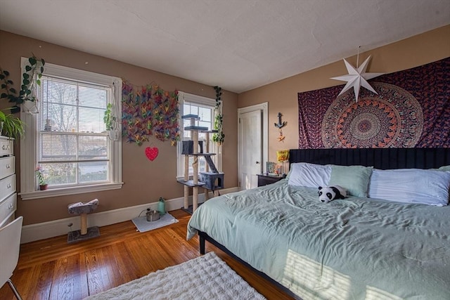 bedroom with baseboards and wood finished floors