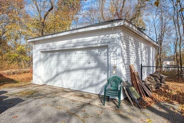 detached garage featuring fence