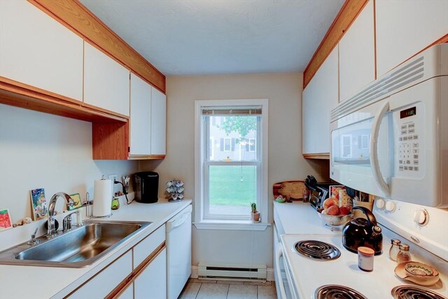 112 Olde Colonial Dr Unit 3, Gardner, MA 01440 - kitchen with white appliances, a baseboard radiator, a sink, light countertops, and plenty of natural light