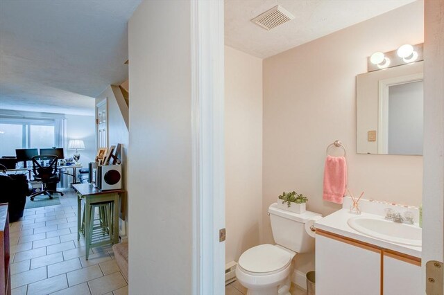 112 Olde Colonial Dr Unit 3, Gardner, MA 01440 - bathroom with toilet, vanity, tile patterned flooring, and baseboard heating