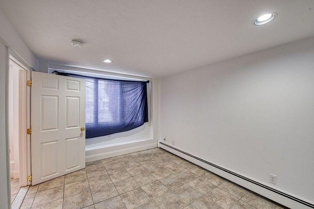 unfurnished room featuring a baseboard radiator