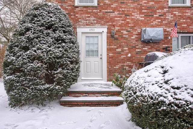 view of snow covered property entrance