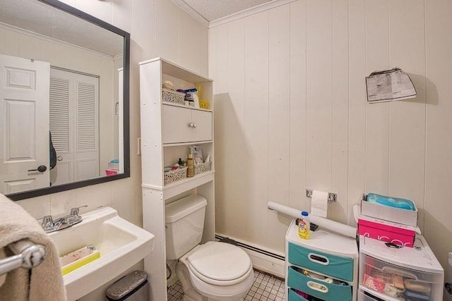 bathroom featuring ornamental molding, a baseboard heating unit, sink, and toilet