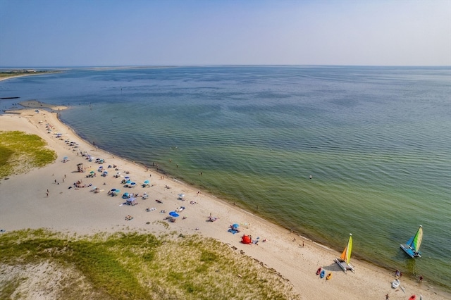 drone / aerial view with a water view and a view of the beach