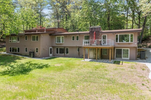 77 Temple Rd, Concord, MA 01742 - rear view of house with a yard, a chimney, central AC unit, and a deck
