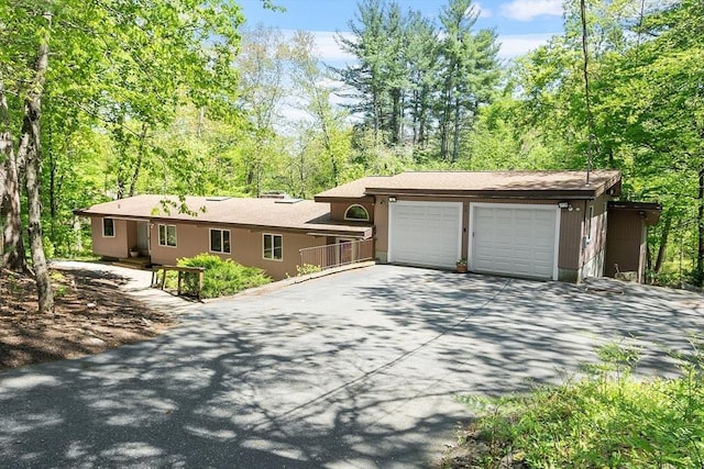 77 Temple Rd, Concord, MA 01742 - view of front facade featuring asphalt driveway and a garage