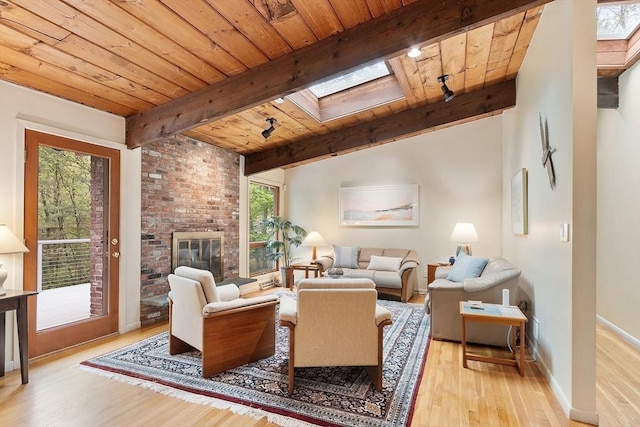 77 Temple Rd, Concord, MA 01742 - living room with a skylight, wood ceiling, light wood-style flooring, beamed ceiling, and a brick fireplace