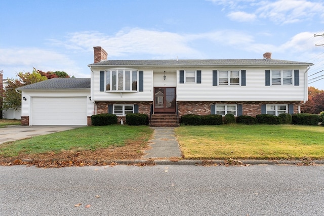 split foyer home featuring a front lawn and a garage