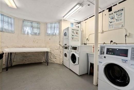 washroom with independent washer and dryer and stacked washer and clothes dryer