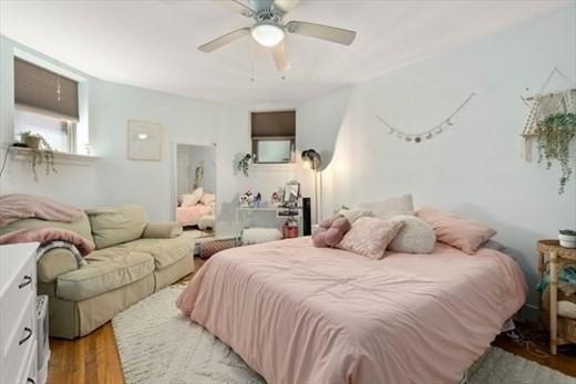 bedroom featuring hardwood / wood-style floors and ceiling fan