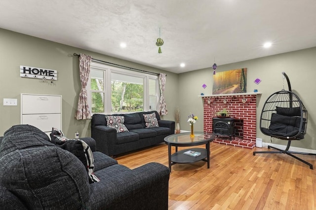 19 Shaker Ln, Littleton, MA 01460 - living room featuring a wood stove, light wood-type flooring, and recessed lighting