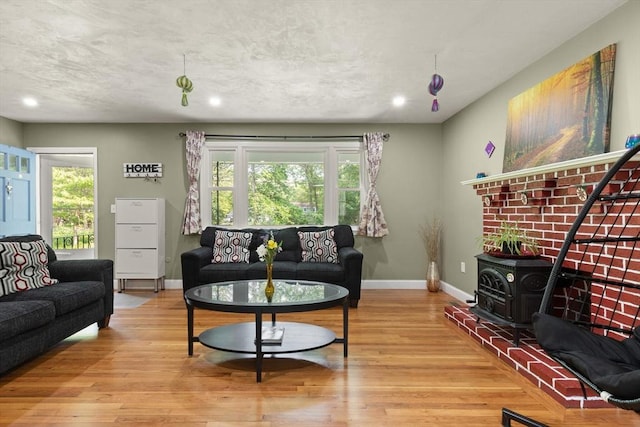 19 Shaker Ln, Littleton, MA 01460 - living room featuring a wood stove, wood finished floors, and recessed lighting