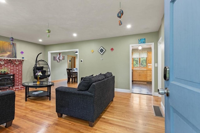 19 Shaker Ln, Littleton, MA 01460 - living room with a wood stove, light wood finished floors, and recessed lighting