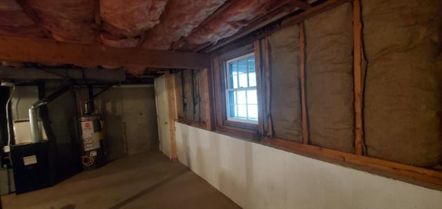 basement featuring water heater and heating unit