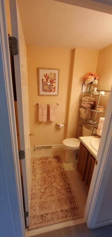 half bathroom with vanity and toilet