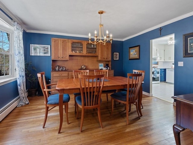 dining room with ornamental molding, baseboards, light wood-type flooring, a baseboard radiator, and a notable chandelier