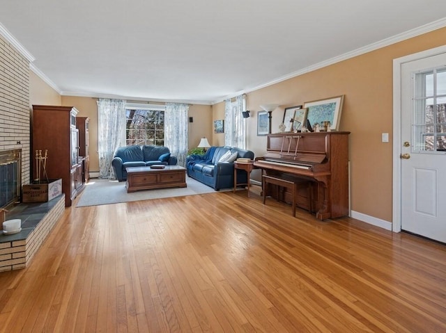 living area with plenty of natural light, light wood finished floors, crown molding, and baseboards