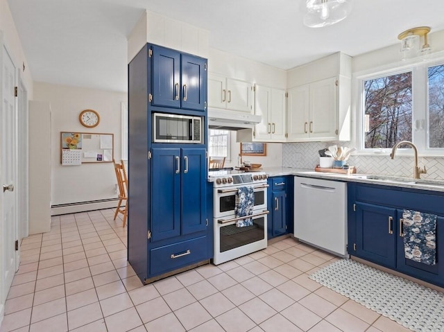 kitchen with blue cabinets, double oven range, dishwasher, a baseboard radiator, and stainless steel microwave