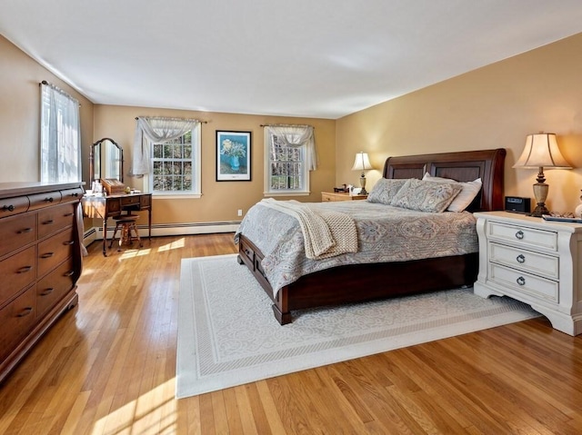 bedroom with a baseboard radiator and light wood-type flooring