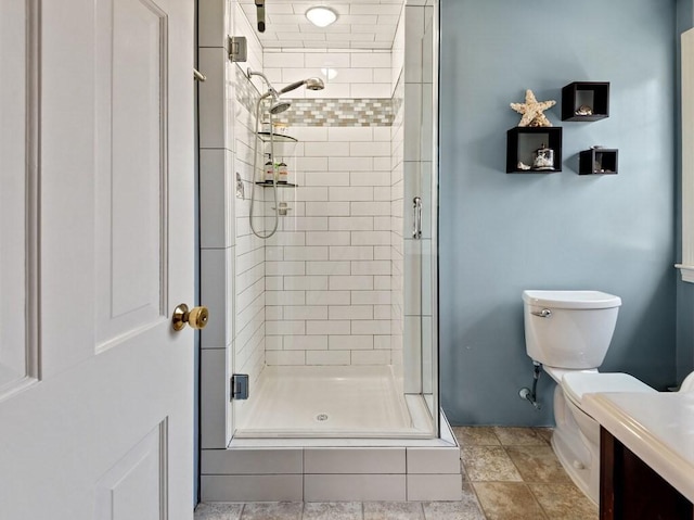 bathroom with vanity, a stall shower, and toilet
